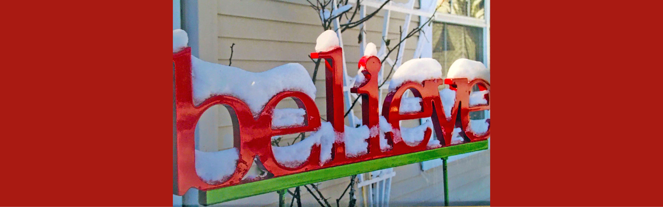 photography of the letters spelling out the word believe, covered with snow