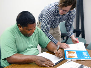 a UDS employee helps a participant during community employment session