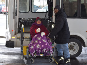 UDS transportation van with wheelchair lift gives ride to a person in wheelchair
